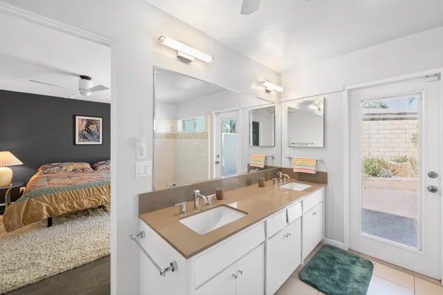 a spacious bathroom with a double vanity sink and a mirror