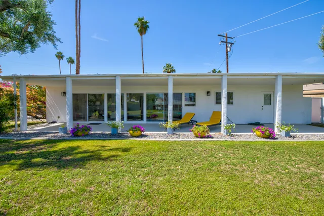 a view of a house with a backyard and porch