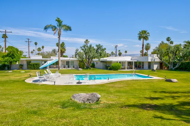 a view of a swimming pool with a yard