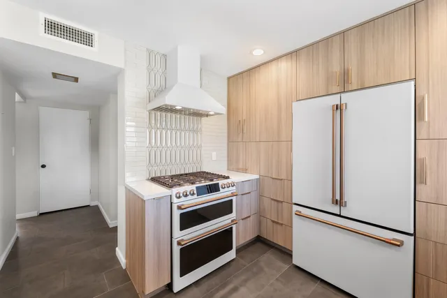 a kitchen with a stove and a refrigerator
