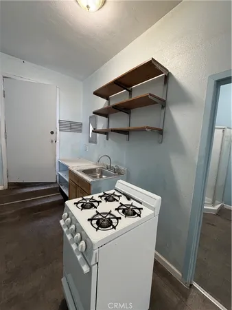 a kitchen with a stove and a refrigerator