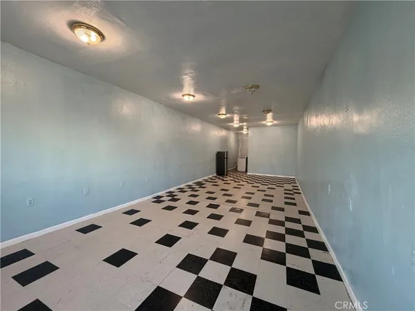 a view of a hallway with a black white checkered floor