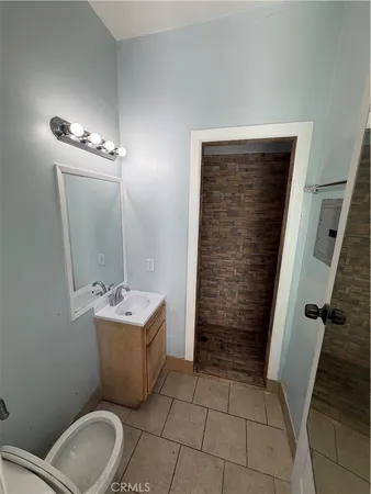 a bathroom with a toilet sink and mirror