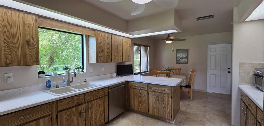 2076 River Basin Terrace Punta Gorda, FL 33982 - Photo 12 of 38 a kitchen that has a sink and a table in it
