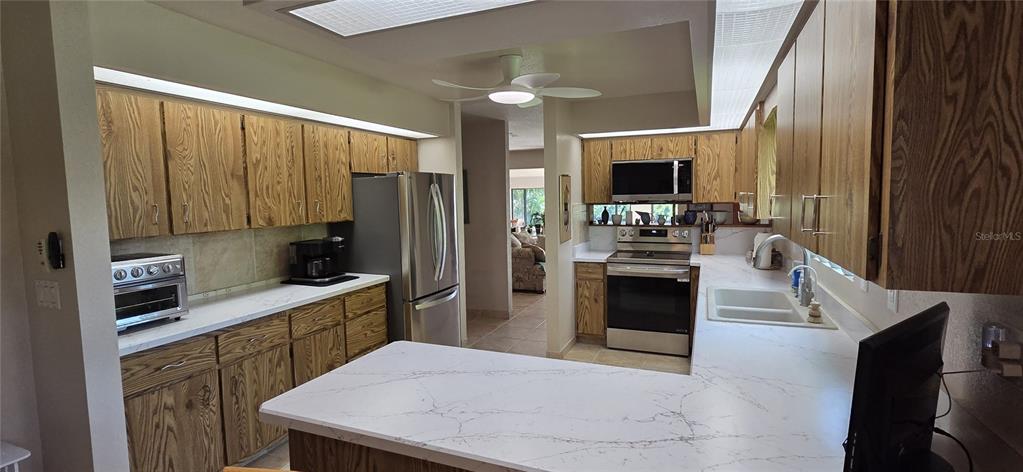 2076 River Basin Terrace Punta Gorda, FL 33982 - Photo 13 of 38 a kitchen with a refrigerator sink and stove