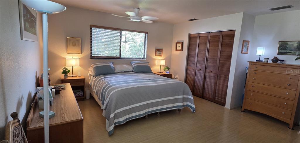 2076 River Basin Terrace Punta Gorda, FL 33982 - Photo 21 of 38 a bedroom with a bed and a dresser