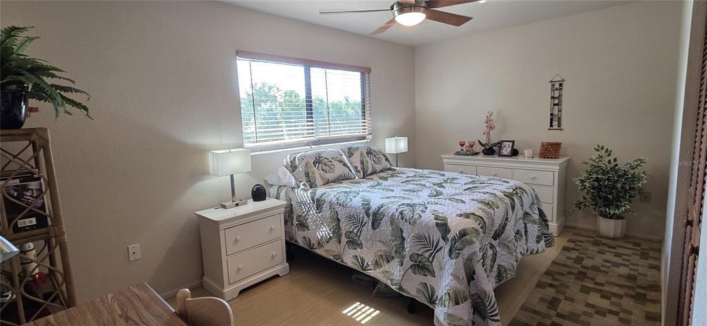 2076 River Basin Terrace Punta Gorda, FL 33982 - Photo 26 of 38 a bedroom with a bed and a chandelier
