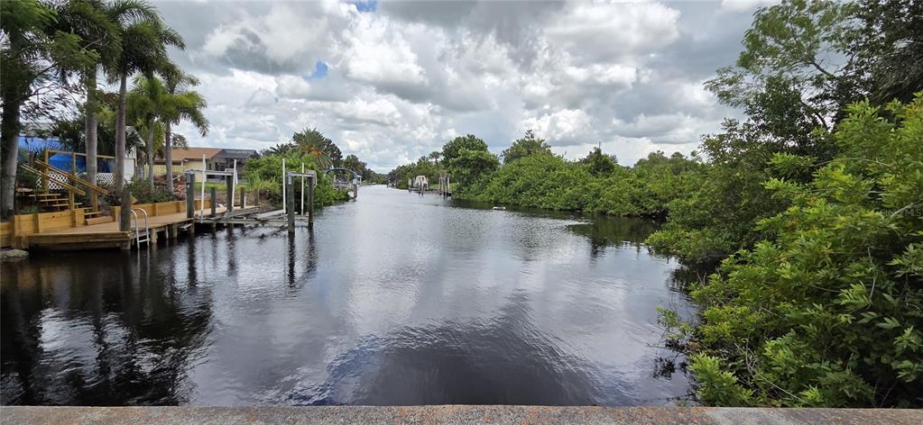 2076 River Basin Terrace Punta Gorda, FL 33982 - Photo 3 of 38 a view of a lake with boats and trees in the background