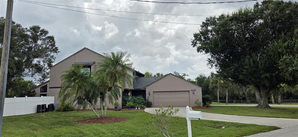 2076 River Basin Terrace Punta Gorda, FL 33982 - Photo 32 of 38 a front view of a house with a yard and trees