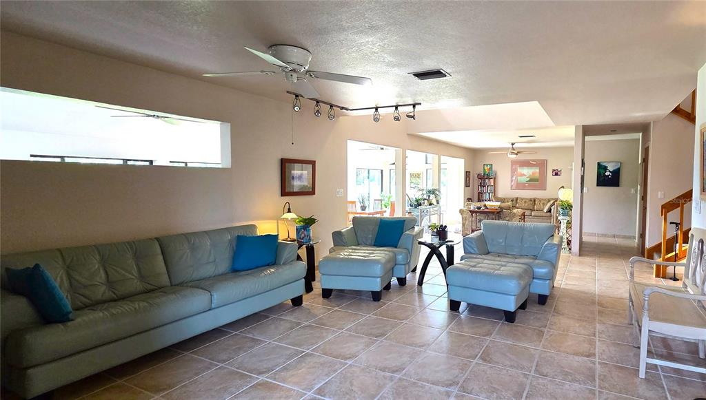 2076 River Basin Terrace Punta Gorda, FL 33982 - Photo 6 of 38 a living room with furniture and a chandelier