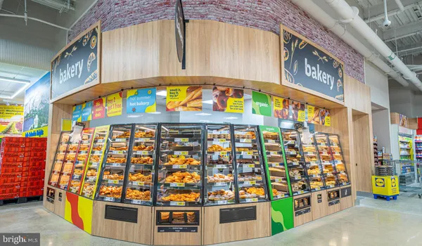 a kitchen with kitchen island a sink appliances and cabinets