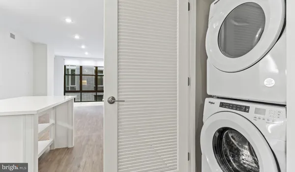 a kitchen with kitchen island a counter top space cabinets and stainless steel appliances