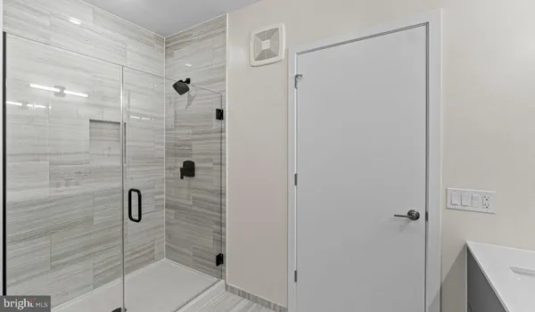 a bathroom with a sink vanity and a mirror