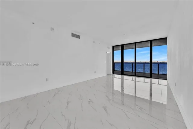 an empty room with sliding glass door and glass door