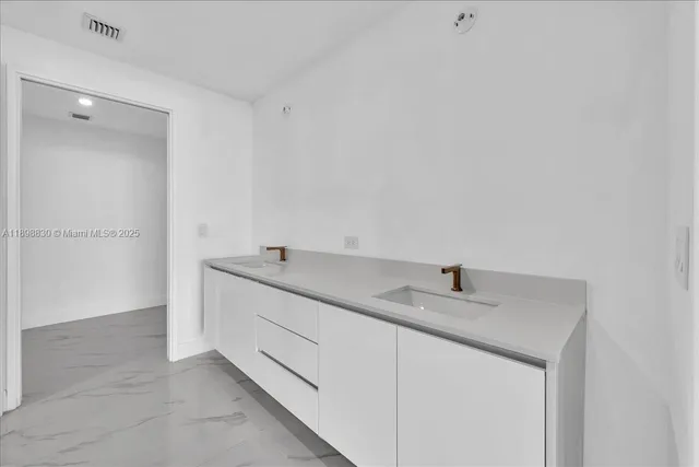 a utility room with cabinets washer and dryer