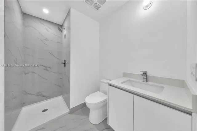 a bathroom with a sink a toilet and bathtub