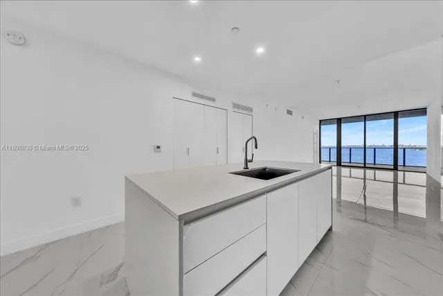 a kitchen with a sink a table and chairs