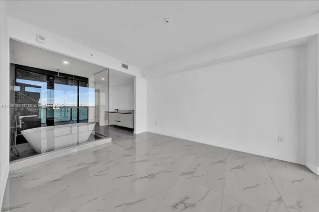 a bathroom with a shower and a glass door