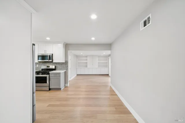 a view of a kitchen with a sink and a stove top oven