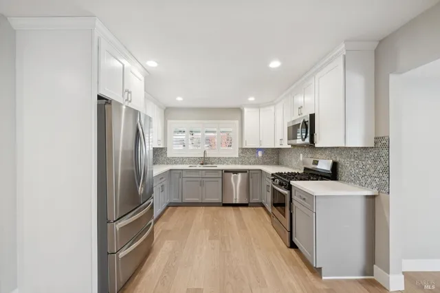 a kitchen with a refrigerator a sink and cabinets