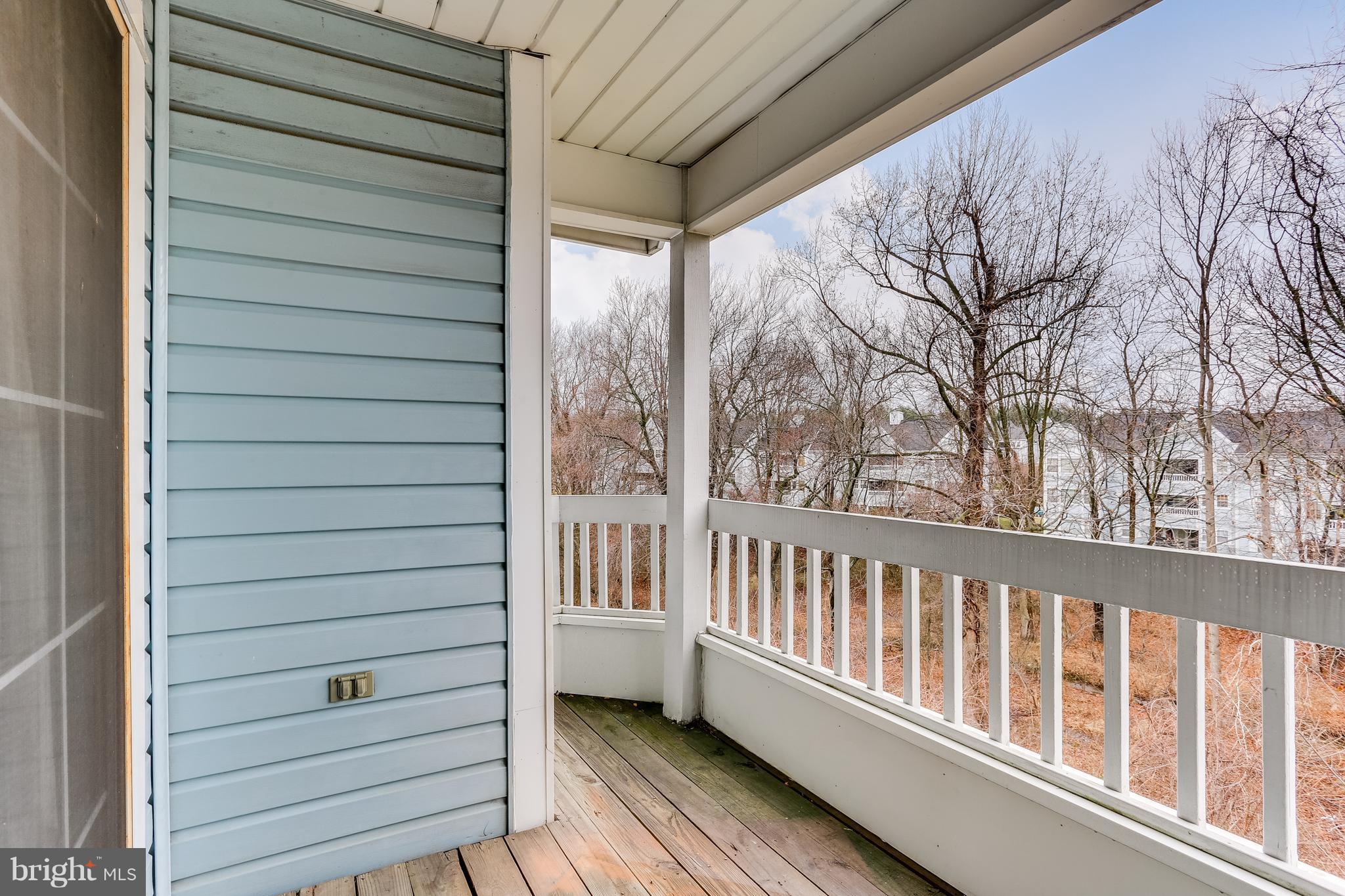8513 Falls Run Road, Unit J Ellicott City, MD 21043 - Photo 29 of 30 Large Rear Deck Faces Trees