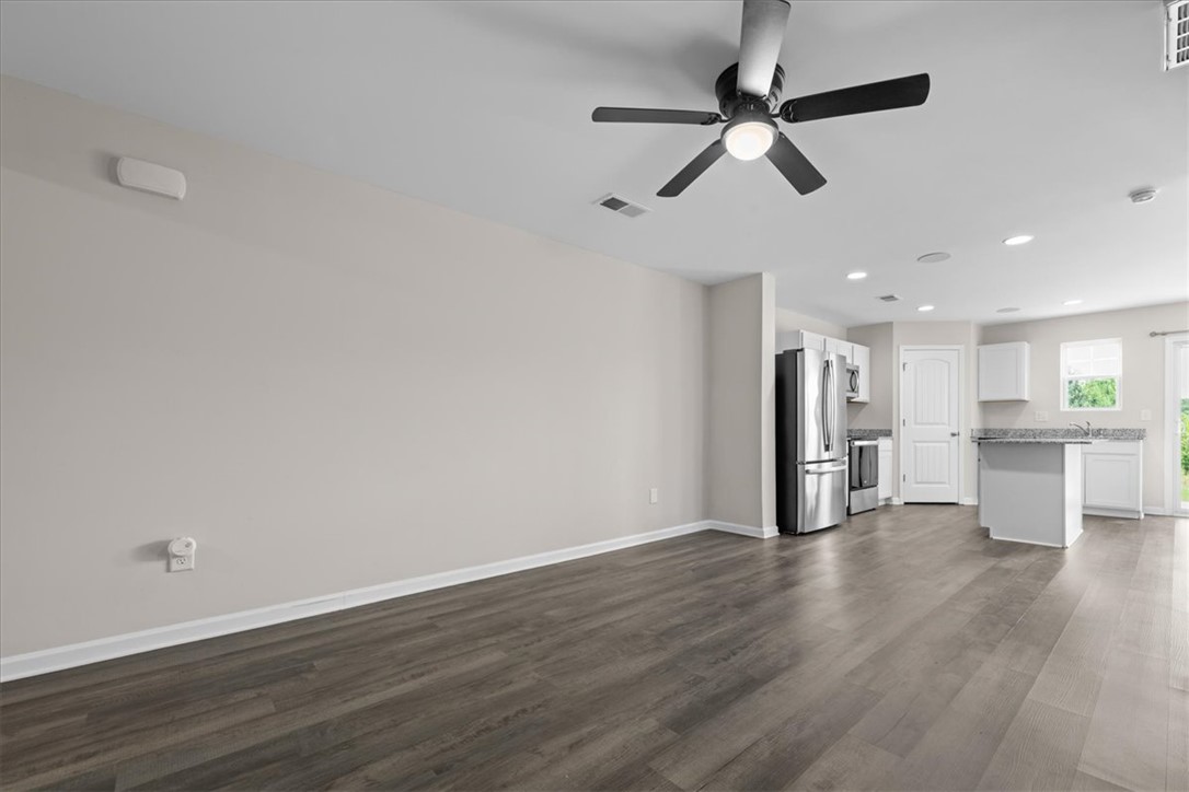 115 Adger Road Pendleton, SC 29670 - Photo 4 of 36 An open concept living area transitions seamlessly to the kitchen, perfect for modern living.