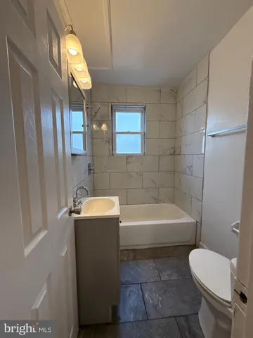 a bathroom with a sink a toilet and bathtub