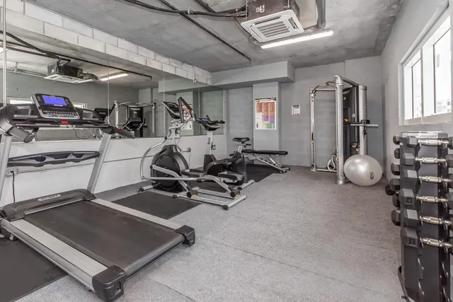 a room with gym equipment and windows