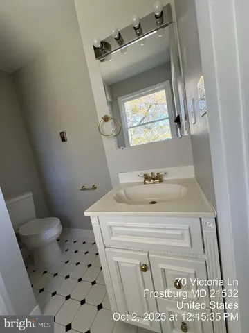 a kitchen with granite countertop a stove top oven and cabinets
