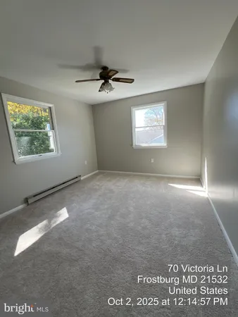 a white bath tub sitting next to a white wall