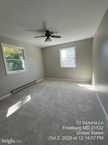 a white bath tub sitting next to a white wall