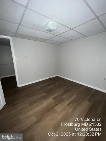 a front view of a house with a yard covered with snow