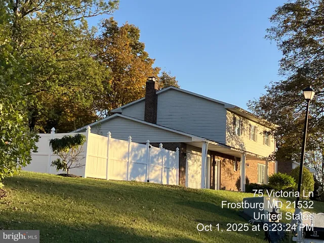 a view of a big house with a big yard and large tree