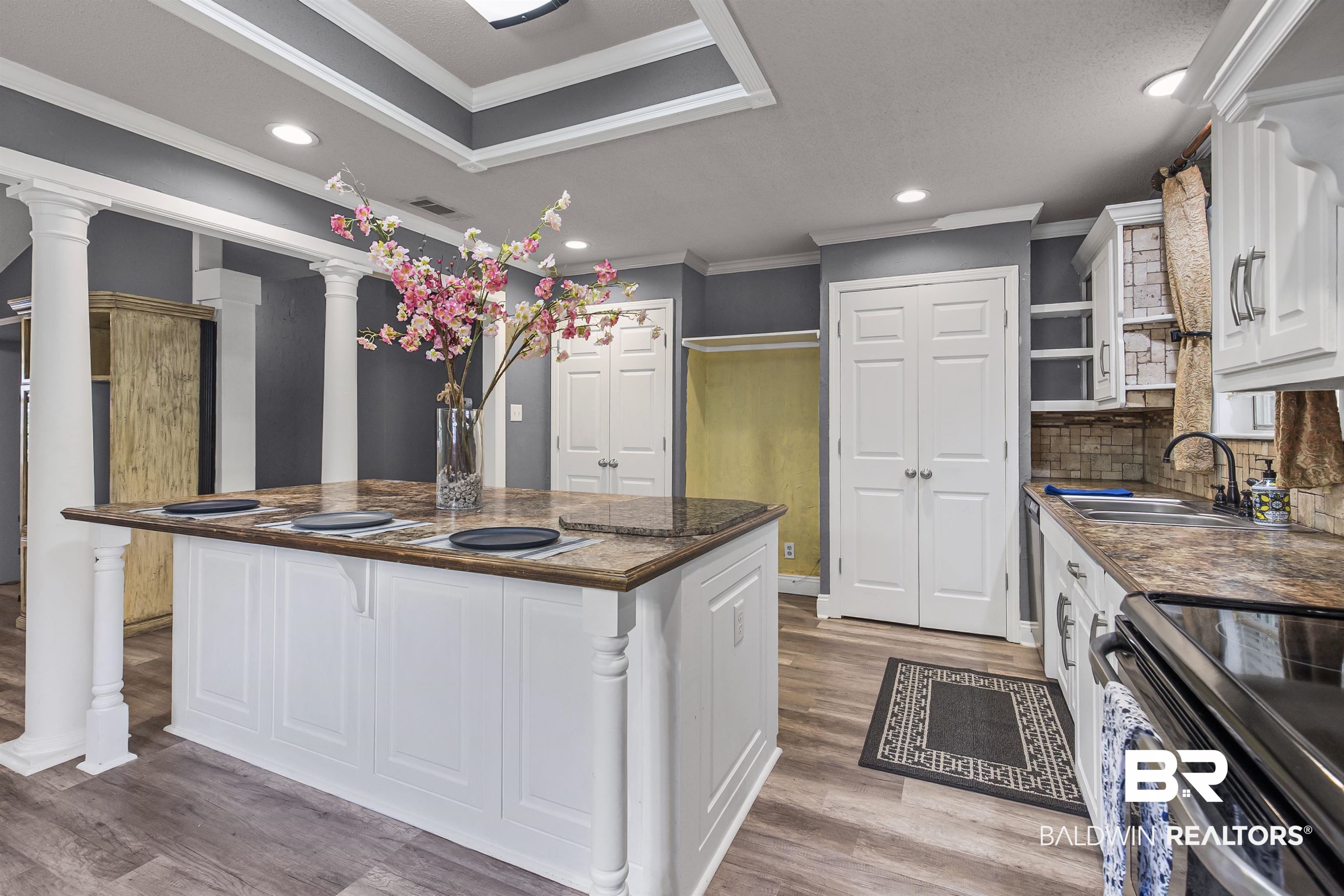 36 Ridgeview Drive Mobile, AL 36611 - Photo 4 of 20 Kitchen featuring white cabinets, recessed lighting, crown molding, light wood finished floors, and stainless steel range with electric cooktop