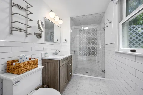 a bathroom with a sink a toilet and shower