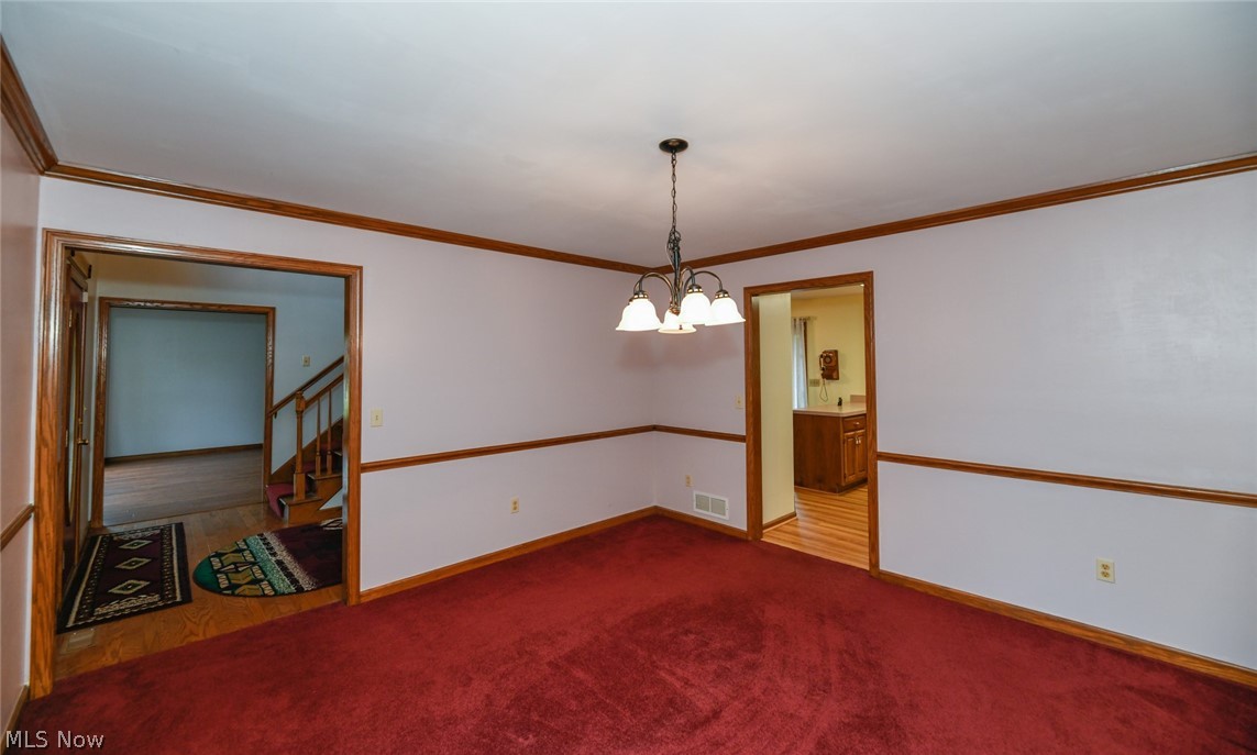 4634 Young Road Stow, OH 44224 - Photo 8 of 35 The spacious dining room boasts newer neutral paint. Would you replace the carpet? If so, with what?