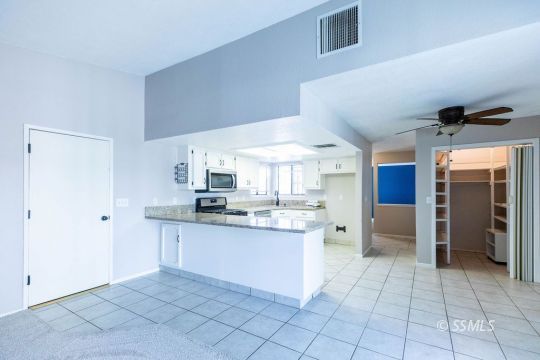 732 South Chesapeake Street Ridgecrest, CA 93555 - Photo 11 of 28 a kitchen with stainless steel appliances a sink and a refrigerator