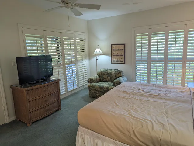 a bedroom with a bed and a television