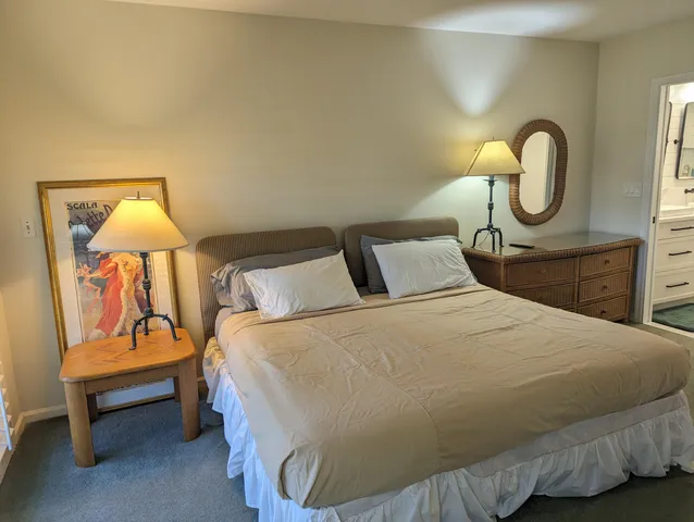 a bedroom with a bed and a lamp on table