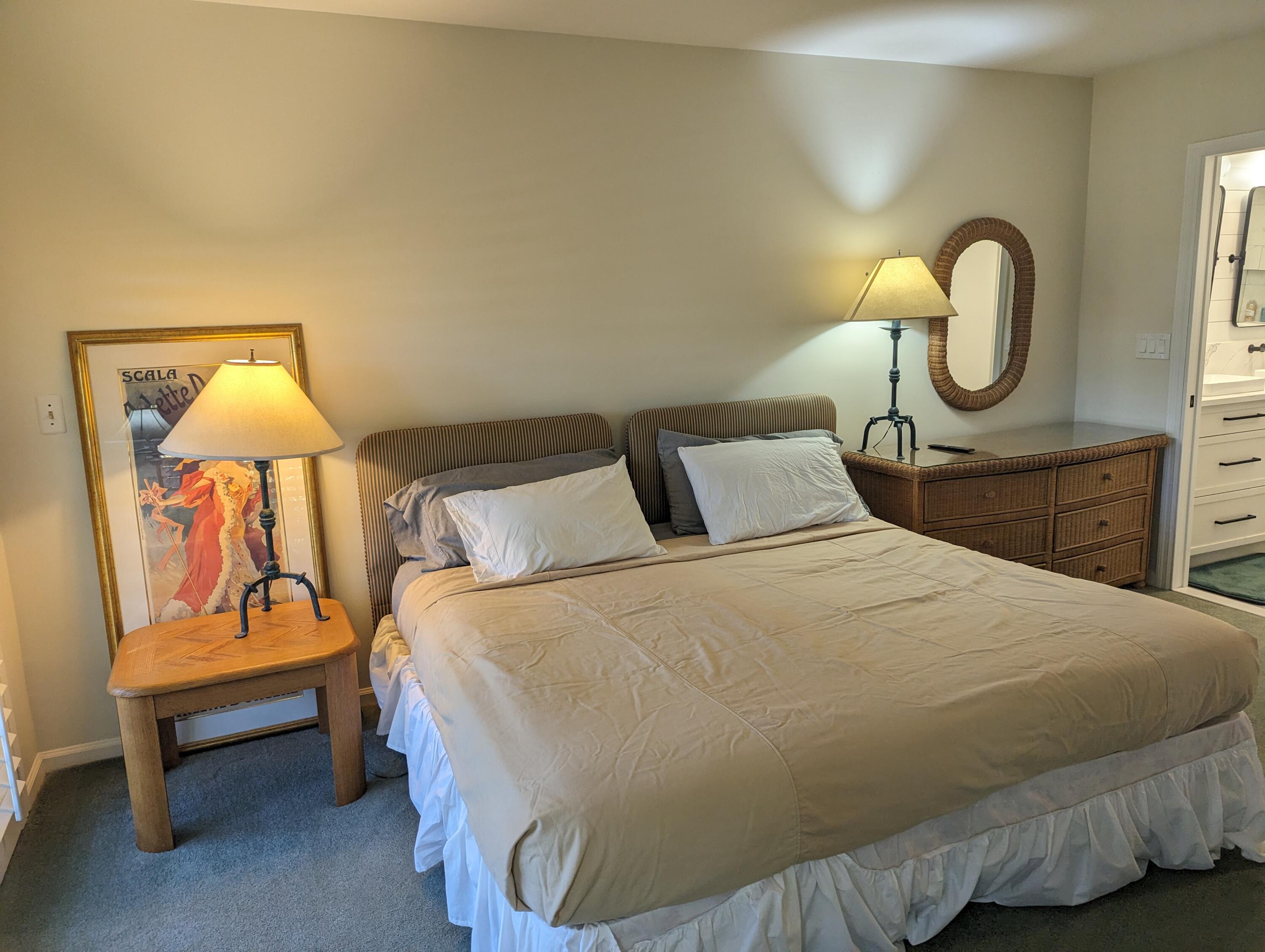 404 Clubhouse Circle Jupiter, FL 33477 - Photo 18 of 26 a bedroom with a bed and a lamp on table