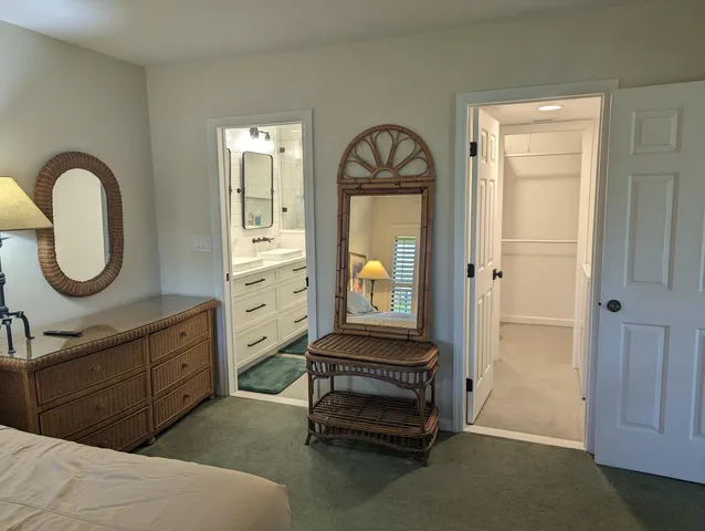 a spacious bedroom with a bed and a dresser