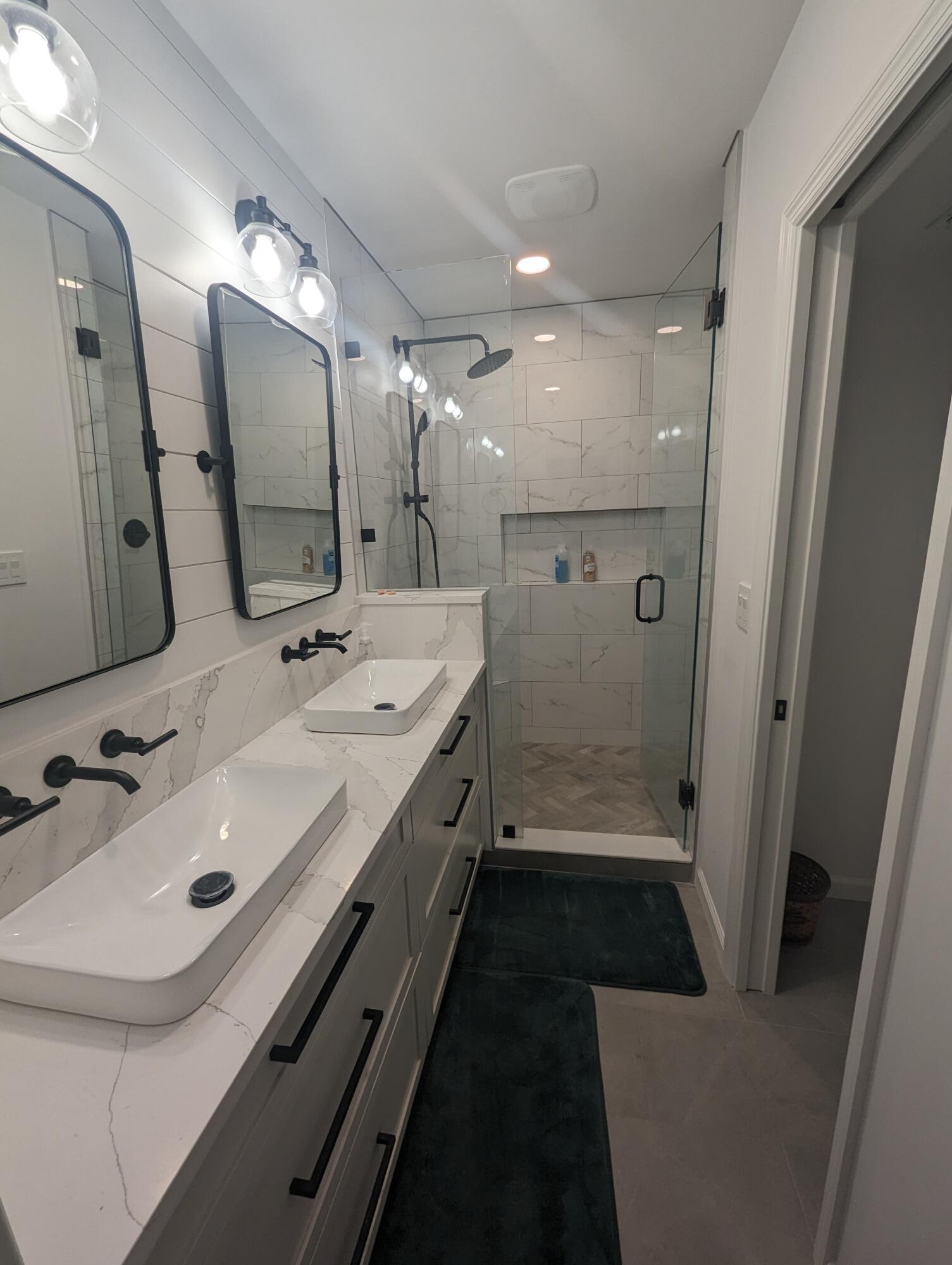 404 Clubhouse Circle Jupiter, FL 33477 - Photo 21 of 26 a bathroom with a double vanity sink and mirror with shower