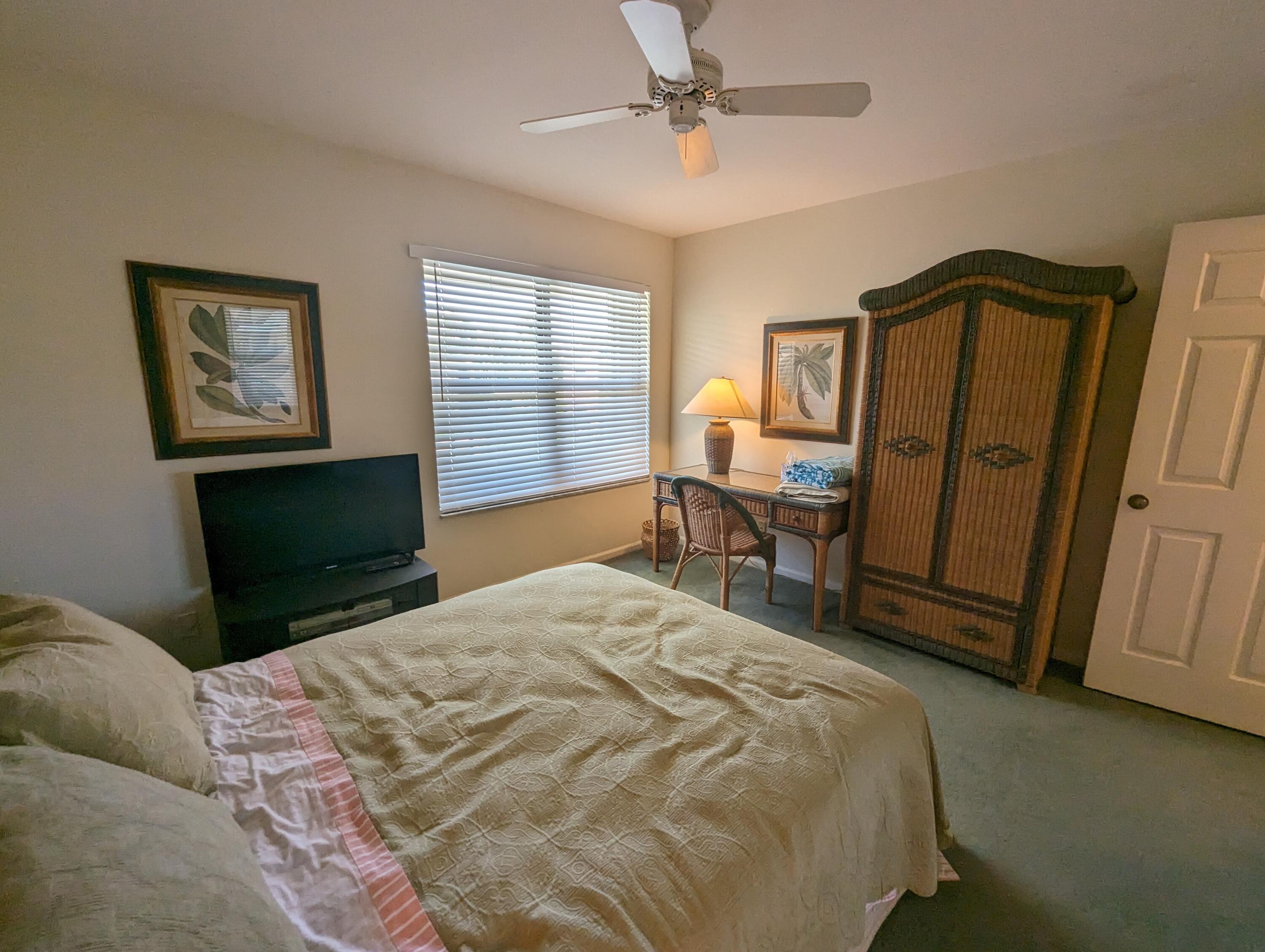404 Clubhouse Circle Jupiter, FL 33477 - Photo 24 of 26 a bedroom with a bed dresser and a window