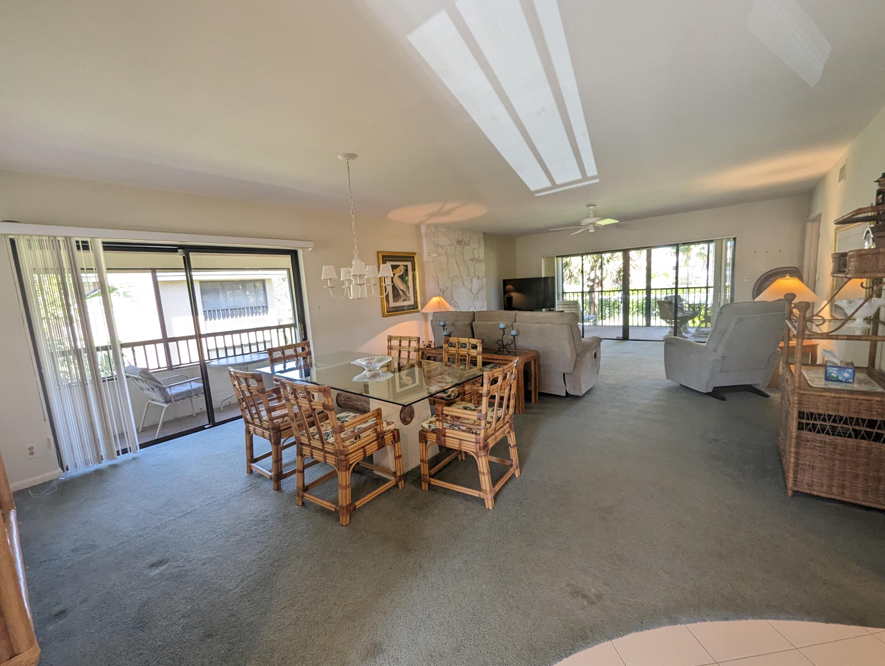 404 Clubhouse Circle Jupiter, FL 33477 - Photo 7 of 26 a living room with furniture and a window