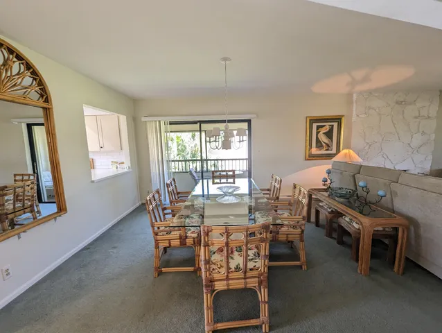 a view of a dining room with furniture and a window