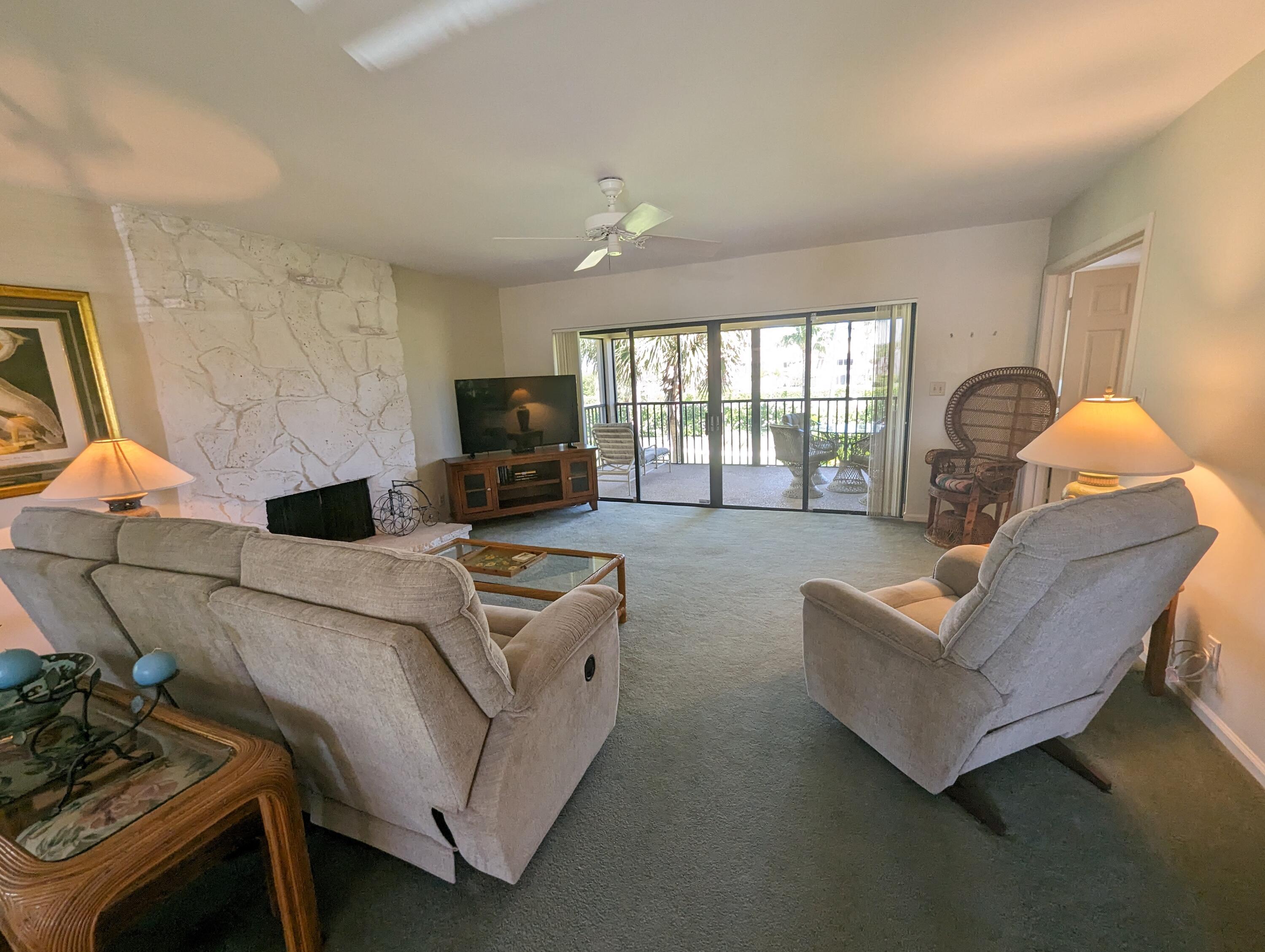 404 Clubhouse Circle Jupiter, FL 33477 - Photo 10 of 26 a living room with furniture and a fireplace