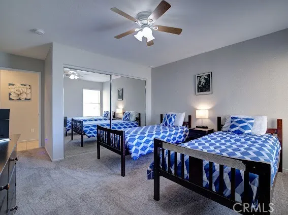 a bedroom with a bed and a tv