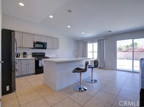 a view of a kitchen with a sink and dishwasher cabinets