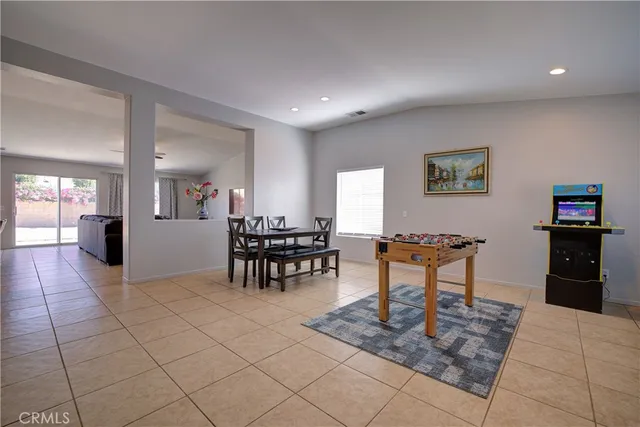 a living room with furniture a dining table and kitchen view