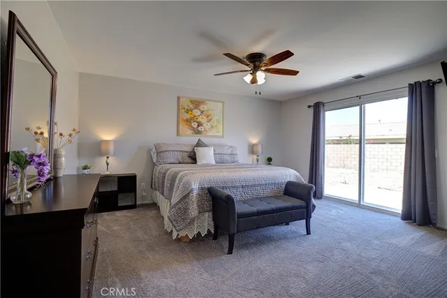 a bedroom with a bed and a large window